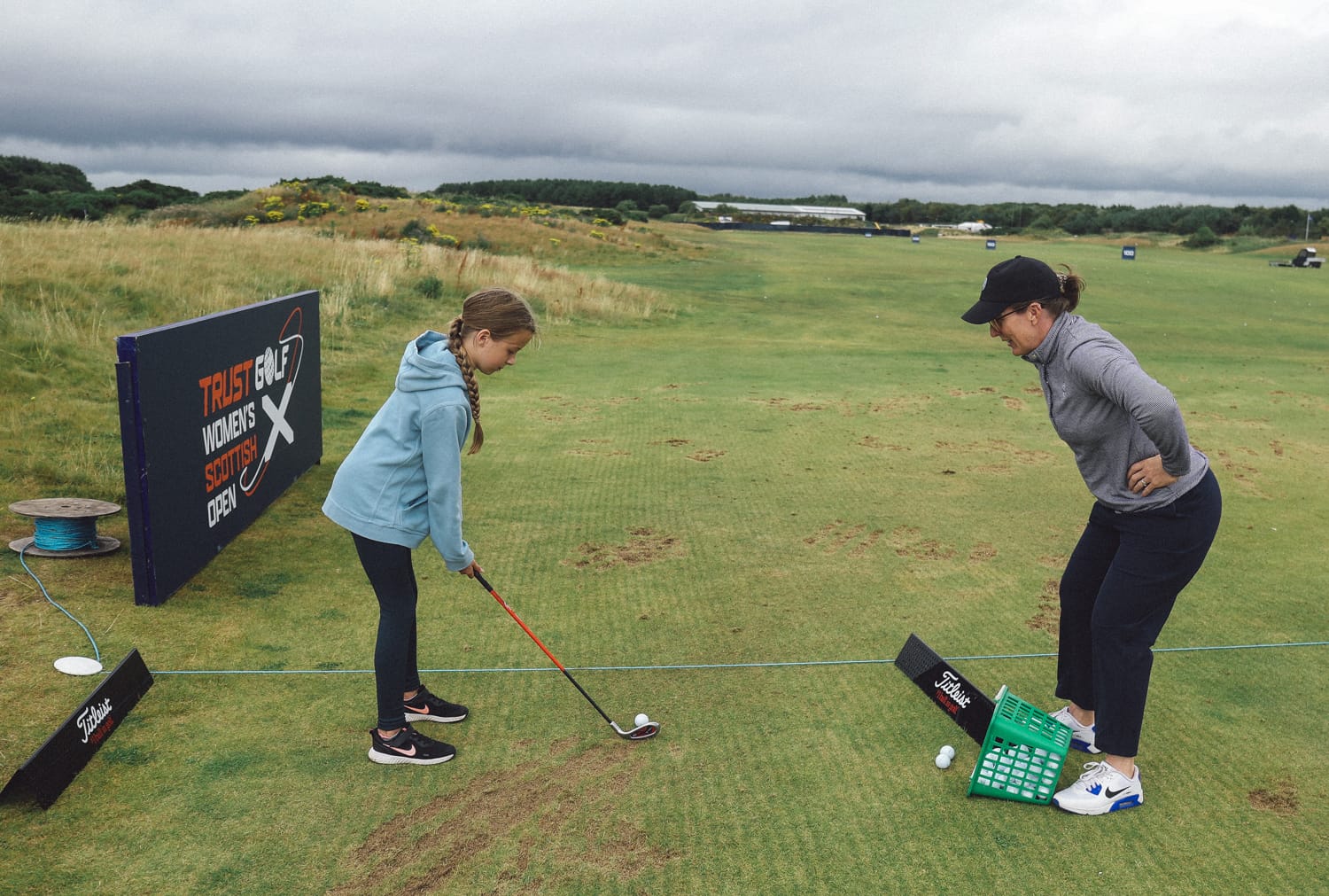 Beth Allen giving a junior girl a golf lesson
